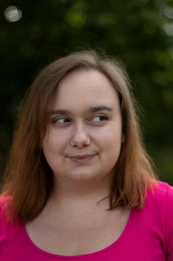 Close up portrait of Plus size woman with brown hair taken outside