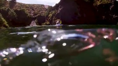 Plus size male swimming and snorkelling in a Welsh quarry 