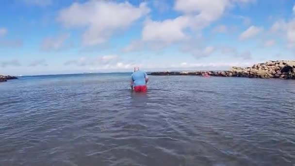 Bald Size Male Wading Out Welsh Sea — Vídeo de Stock