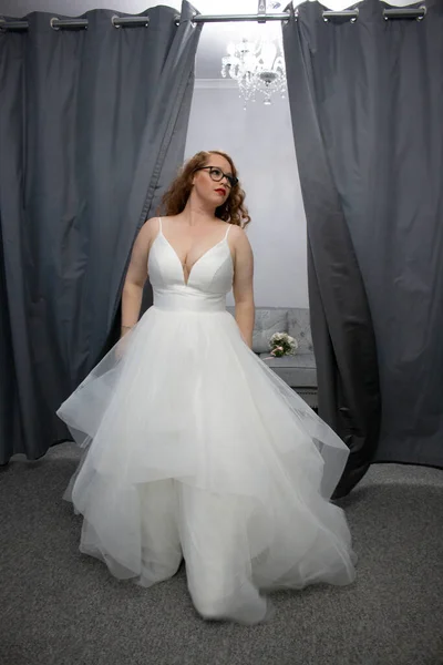 beautiful plus size red head woman wearing a elegant wedding dress