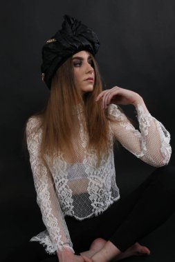 beautiful elegant female wearing a headdress and a vintage inspired white shirt