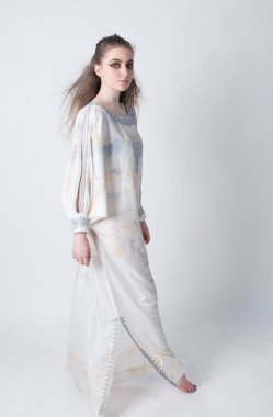 beautiful elegant female wearing a white African inspired dress