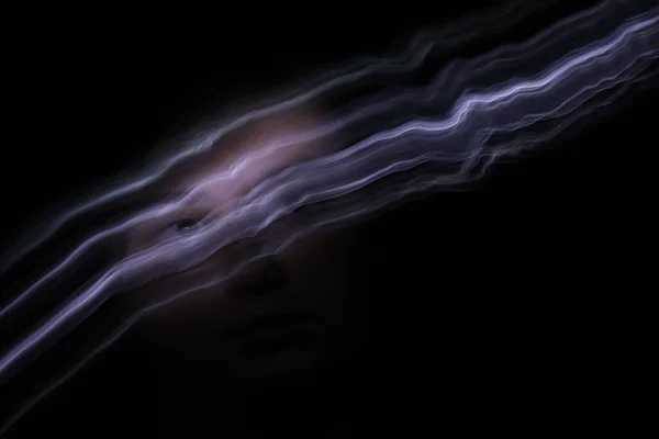 plus size woman with long exposure light trails in front of face