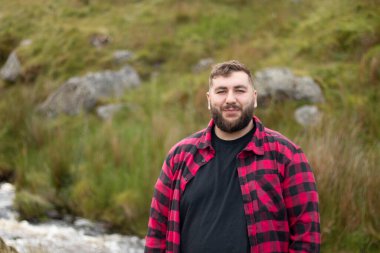 Portrait of plus size strong handsome man out on a travel adventure