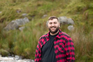 Portrait of plus size strong handsome man out on a travel adventure