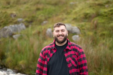 Portrait of plus size strong handsome man out on a travel adventure