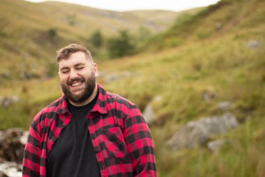 Portrait of plus size strong handsome man out on a travel adventure