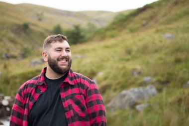 Portrait of plus size strong handsome man out on a travel adventure