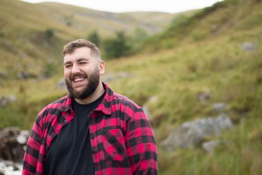 Portrait of plus size strong handsome man out on a travel adventure