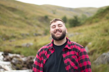 Portrait of plus size strong handsome man out on a travel adventure