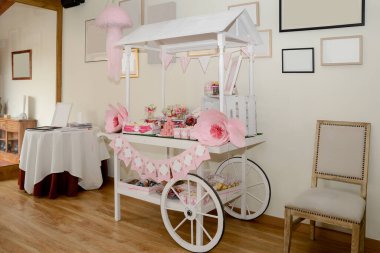 Bir etkinlik için beyaz ve pembe posterli güzel bir şeker arabası..