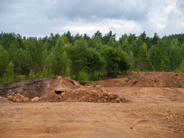 Mystierious cave opening in the distance in an orange post apocalyptic landscape Falu Copper Mine World Heritage Sweden