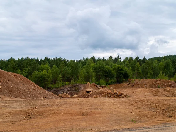 Mystierious cave opening in the distance in an orange post apocalyptic landscape Falu Copper Mine World Heritage Sweden