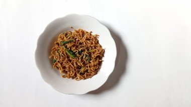 noodles cooked with a mixture of mustard greens with white background