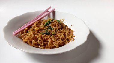 noodles cooked with a mixture of mustard greens with white background