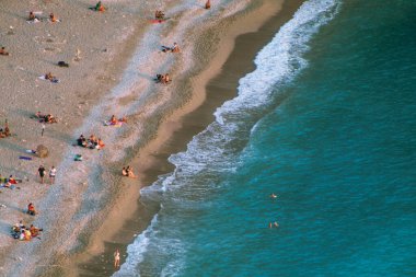Fethiye, Mugla, Turkey - September 2021: Top view of people vacationing at Kabakkoyu beach, Selective Focus