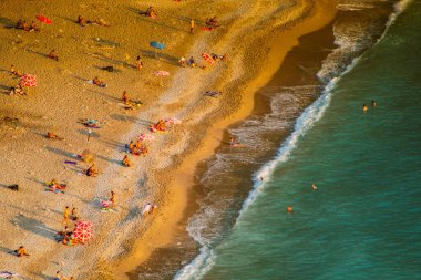 Fethiye, Mugla, Turkey - September 2021: Top view of people vacationing at Kabakkoyu beach, Selective Focus