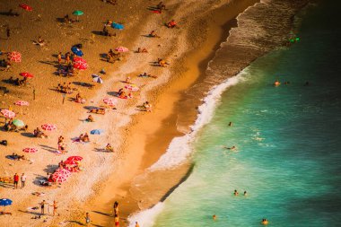 Fethiye, Mugla, Turkey - September 2021: Top view of people vacationing at Kabakkoyu beach, Selective Focus