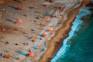 Fethiye, Mugla, Turkey - September 2021: Top view of people vacationing at Kabakkoyu beach, Selective Focus