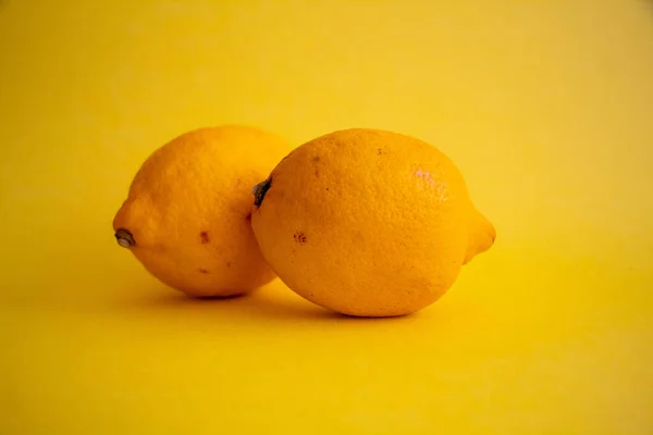 Lemons on the isolated yellow background, selective focus, noise effect