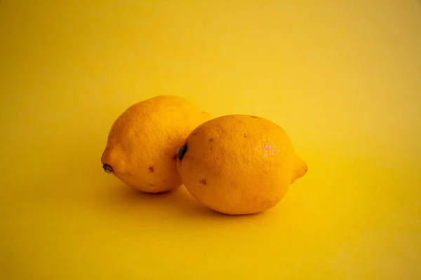 Lemons on the isolated yellow background, selective focus, noise effect