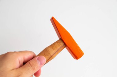 Hand held wooden handle hammer and orange head, isolated white background, straight peen hammer, selective focus