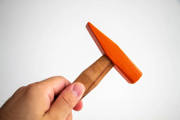 Hand held wooden handle hammer and orange head, isolated white background, straight peen hammer, selective focus