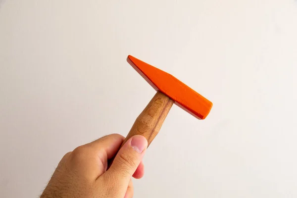 Hand held wooden handle hammer and orange head, isolated white background, straight peen hammer, selective focus