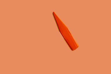 Orange head of invisible hammer on the isolated orange background, selective focus, noise effect