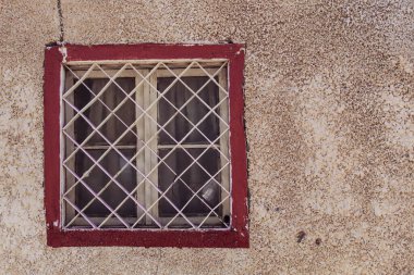 A white window, red painted frame and dirty wall, selective focus