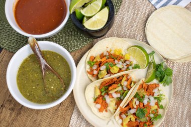 Shot of mexican al pastor tacos with salsas