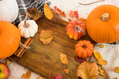 Balkabağı, balkabağı, yapraklar, meşe palamudu ve ahşap masa üzerindeki diğer süslemelerle sonbahar arkaplanı