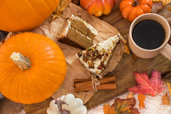 pumpkin cake with cinnamon and pumpkin seeds on a wooden table