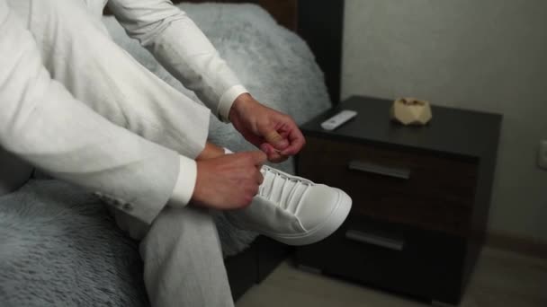 Man Suit Putting White Sneakers — Stockvideo