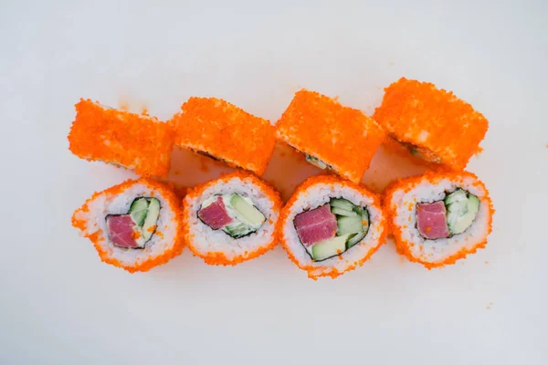 a Japanese roll with tuna and white rice in tobiko caviar