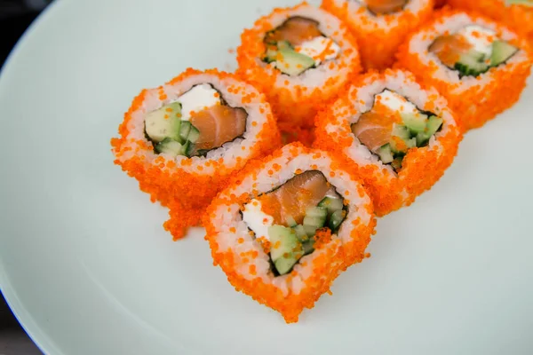 a Japanese roll with tuna and white rice in tobiko caviar