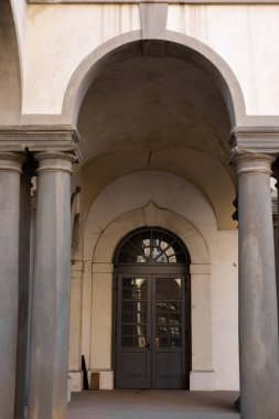 İtalya 'da tarihi mimarinin antik bir binasında sütunları olan bir kemer.