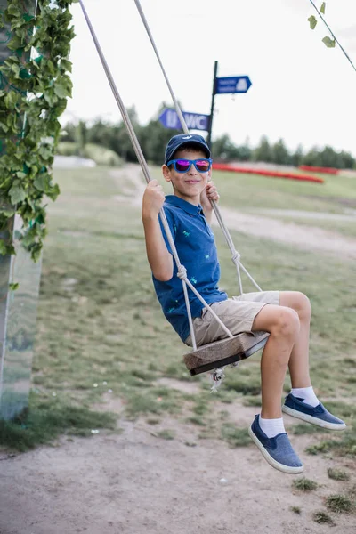 Boy Sunglasses Rides Swing Park Summer — Stock Photo, Image