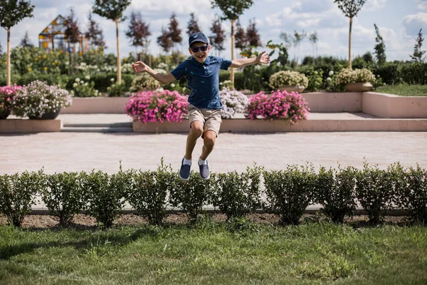 boy jumping for joy in the park