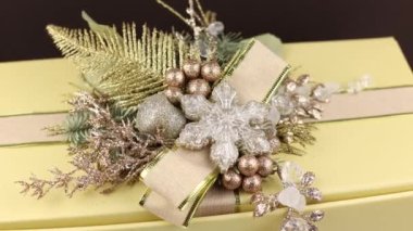 New Year's decor on a box with a gift. Background of the holiday of the new year of Christmas with cones and branches of a Christmas tree.