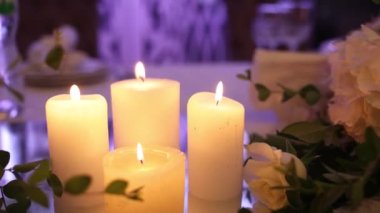 candles burn on the wedding table in the restaurant