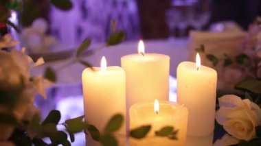 candles burn on the wedding table in the restaurant