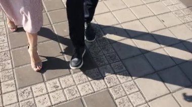 a man with a woman walk along a zebra crossing in the city