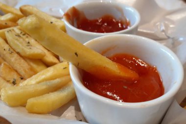 Delicious french fries with tomato and chili sauce