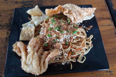 Delicious noodle with extra chili and dumplings