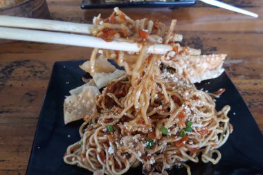 Delicious noodle with extra chili and dumplings