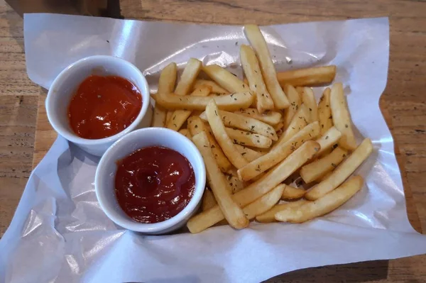 Delicious french fries with tomato and chili sauce