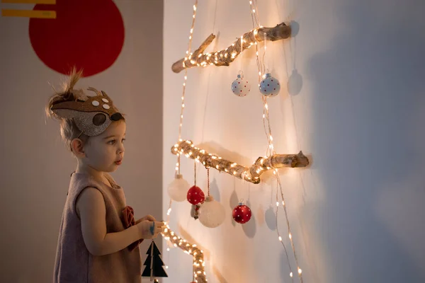 Κοριτσάκι που στολίζει χριστουγεννιάτικο δέντρο στο σπίτι. Οικολογική εναλλακτική λύση χριστουγεννιάτικο δέντρο — Φωτογραφία Αρχείου