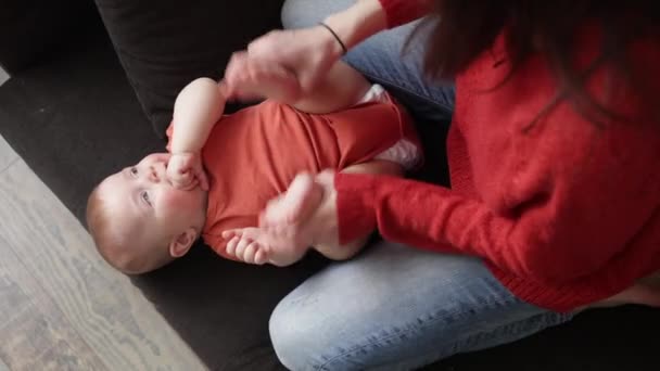 Jonge vrolijke vrouw die met haar baby baai speelt. Moeder brengt tijd door met haar baby. Moederschap — Stockvideo