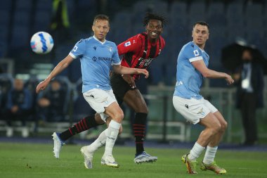 ROME, Italy - 24.04.2022:  LUCAS LEIVA (LAZIO), LEAO (MIL) in action during the Italian Serie A football match between SS LAZIO VS AC MILAN at Olympic stadium in Rome